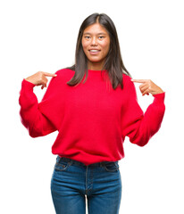 Young asian woman wearing winter sweater over isolated background looking confident with smile on face, pointing oneself with fingers proud and happy.