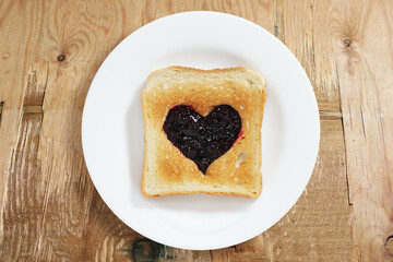 Toast with jam in the shape of a heart