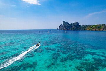 longtail boat turquoise clear water in Phi Phi, Krabi Thailand. Amazing travel landscape photo in...