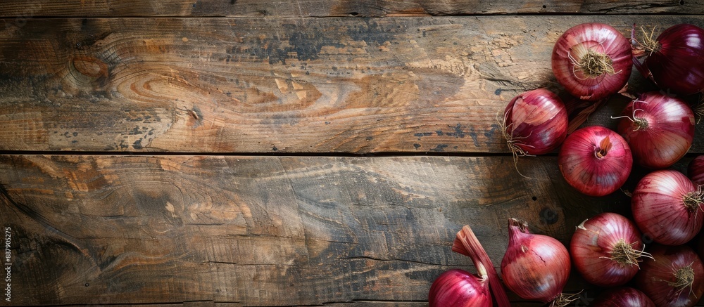 Poster Old rustic wood table background with Spanish onions creating copy space image