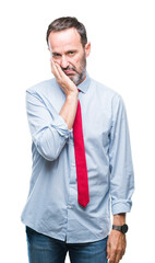 Middle age hoary senior business man wearing red tie over isolated background thinking looking tired and bored with depression problems with crossed arms.