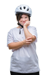 Young adult cyclist woman with down syndrome wearing safety helmet over isolated background looking stressed and nervous with hands on mouth biting nails. Anxiety problem.
