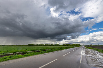A road with a cloudy sky above it