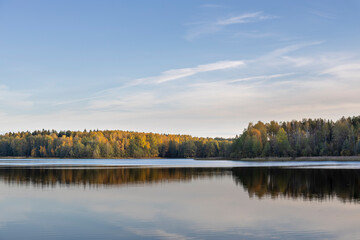 A calm lake with trees in the background