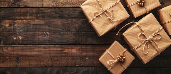 Fototapeta premium Gift boxes with decorative cords arranged on a wooden background perfect for a copy space image