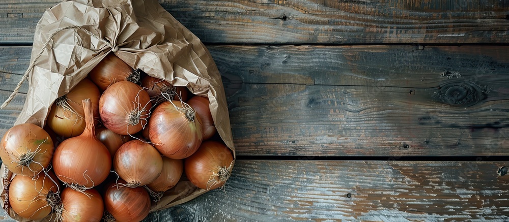 Poster organic onions in a paper bag on a wooden background with selective focus and top view for a bio pro