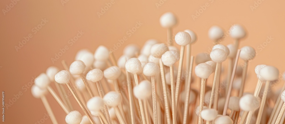 Poster beige background with numerous wooden cotton buds ideal for adding text copy space image