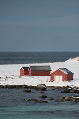 Red Cabins by Snowy Coastline