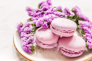 spring woman breakfast with macaroons and mauve flowers white background