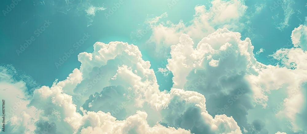 Poster copy space image of a textured blue sky with fluffy white clouds in the background featuring selecti