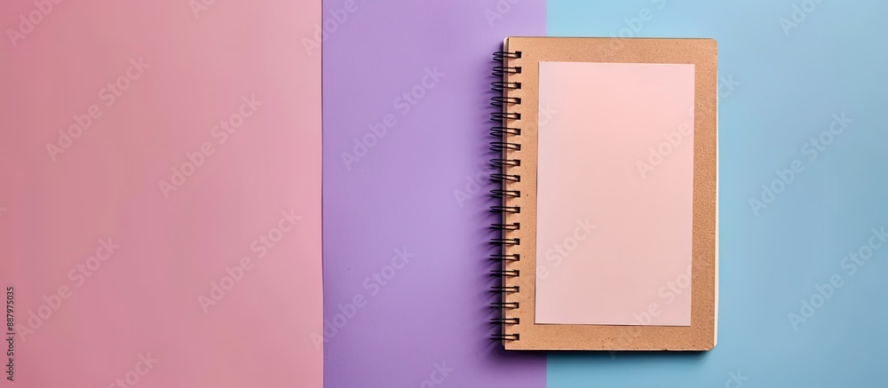 Poster top view of spiral kraft notebook with purple and white open page isolated on background for a mocku