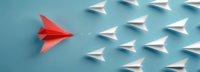 A red paper plane leads a group of white planes on a blue background banner with copy space area