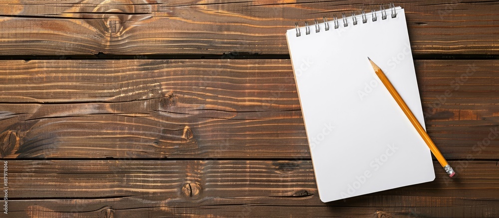 Poster wooden table with clear notepad pencil and pen offering ample copy space image
