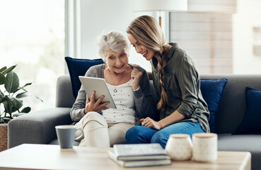 Tablet, happy and woman with senior mother in home for help with online blog, internet or...