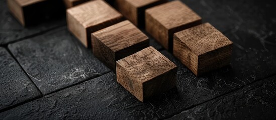 Wooden blocks illustrating a code of ethics on a striking black table with a dark background emphasizing the business ethics theme featuring copy space image