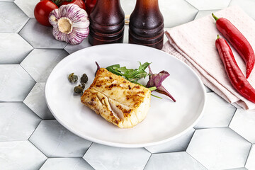 Roasted cod fish steak with salad