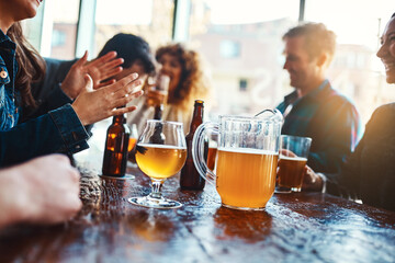 Bar, group and hands for beer, fun and party for joy, reunion and celebration for friends and event. Table, alcohol and drinks to enjoy, glass and people in club, break and together in Los Angeles