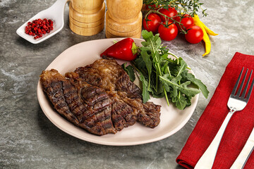 Grilled chuck roll steak with arugula