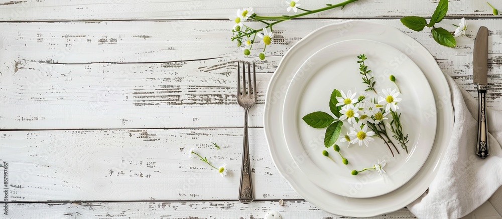 Poster top view of a spring themed table setting on a white wooden table with ample copy space for an image