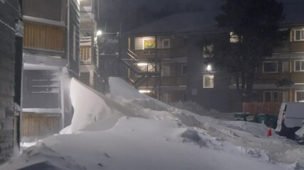 A strong snowstorm hit the city of Dartmouth at night, cars and houses were covered with snow. Shows snow and snow storms in winter.Great for an urban winter theme.Nova Scotia, February 2024 