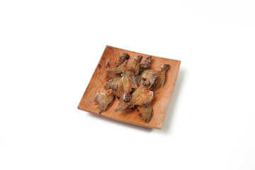 Fried salted fish or ikan asin sepat (Trichopodus trichopterusis) is a famous dish in Indonesia. Isolated and copy space on white background.