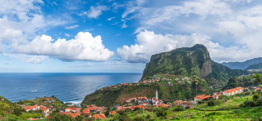 Landscape with Eagle Rock and charming village of Faial in Madeira with stunning ocean views and lush landscapes.