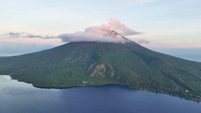 A serene dawn illuminates the scenic volcano of Lewotolok on island of Lembata, Indonesia. This beautiful and biodiverse area is part of the famed Ring of Fire and is volcanically active.
