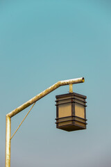 A simple design of a street light with a single arm and rectangular-shaped lamp