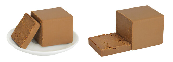 Brown cheese. Norwegian brunost in a ceramic bowl isolated on white background with full depth of field