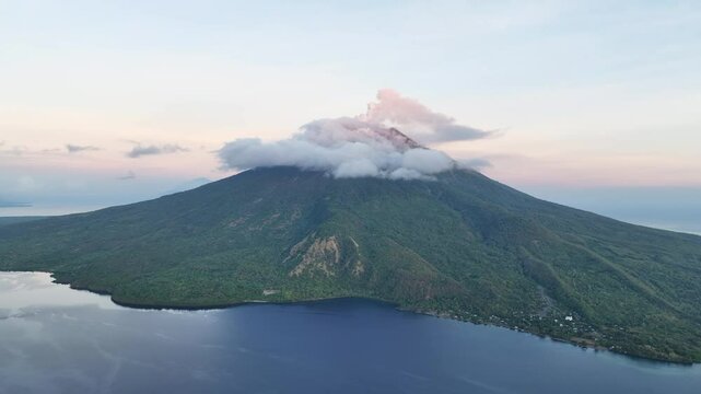 A serene dawn illuminates the scenic volcano of Lewotolok on island of Lembata, Indonesia. This beautiful and biodiverse area is part of the famed Ring of Fire and is volcanically active.