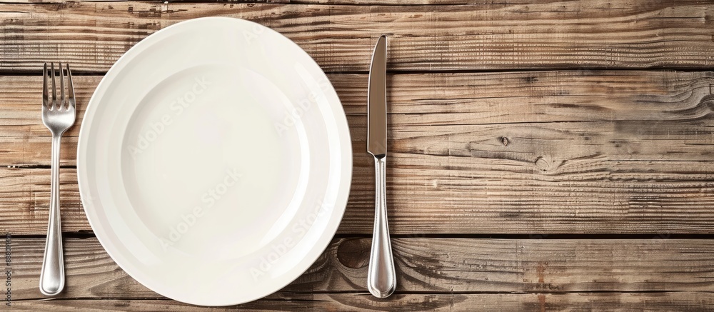 Aufkleber table setting featuring an empty plate with cutlery on a wooden table ready for a meal with a design