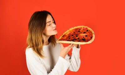 Woman eating pizza. Takeaway yummy pizza. Smiling girl holding delicious pizza in hands. Fast food...