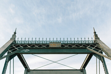 metal bridge with clouds in background