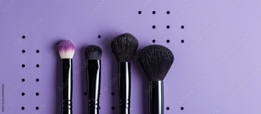 Poster high quality makeup brushes held against a purple backdrop with visible holes suitable for adding te