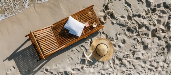 Aerial view of a straw sunbed on sandy beach adorned with a swimsuit towel sunblock and a starfish creating a relaxed beach concept featuring copy space image