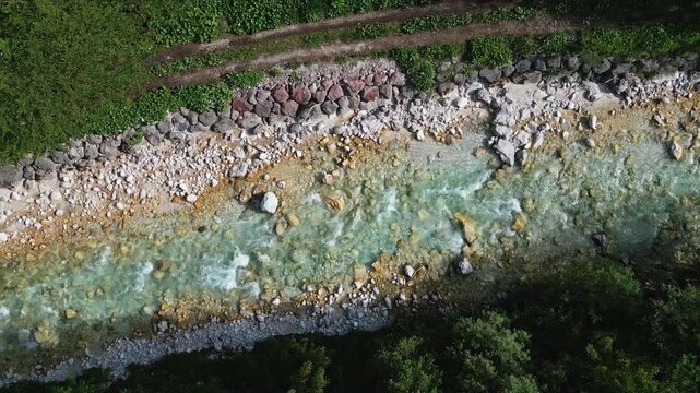 Aerial top view of river Triglavska Bistrica in Slovenian Alps. Forest ecosystem and health concept background. Nature scenery green forest with river