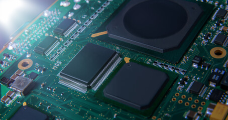 Obraz premium Detailed closeup of an electronic circuit board showcasing microchips, resistors, and other components, representing modern technology and hardware.