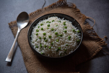 Ready to eat matar or peas pulao or pilaf served in a bowl. Close up view. 