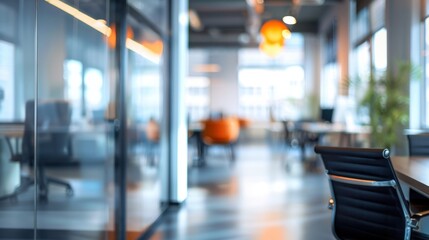 Grey office interior with panoramic windows, glass partitions, and orange accents against a blurred background.