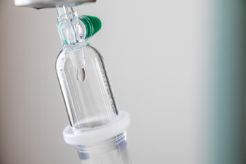 Close up medical intravenous IV drip in hospital background