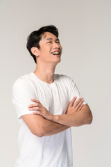 Portrait of young smiling asian man over white background