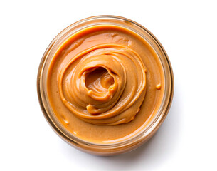 Peanut paste in a jar top view, the texture of the cream is brown