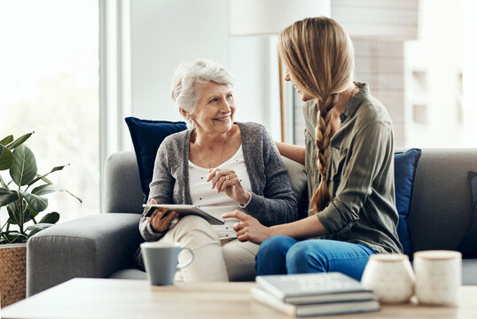 Tablet, living room and woman with senior mother in home for help with online blog, internet or connectivity. Bonding, sofa and elderly female person learning digital technology with daughter.