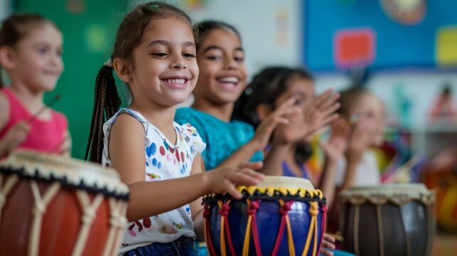 Happy children playing traditional drums and smiling during a kindergarten music session