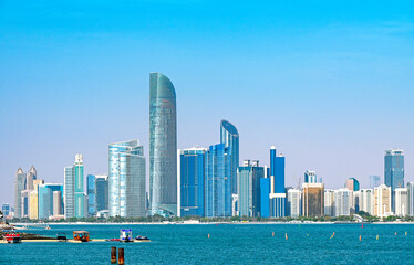 Panoramic view of Abu Dhabi with sea, waterfront Corniche, skyscrapers during sunny day in United...