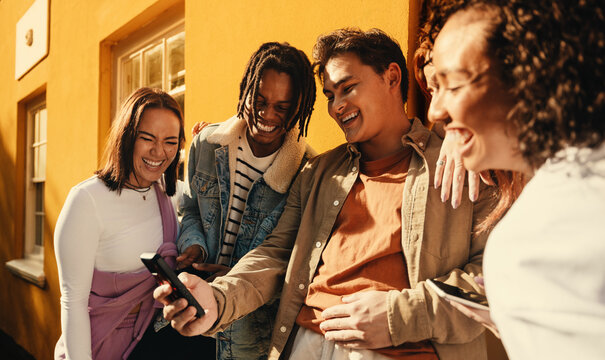 Group of friends enjoying outdoor time and sharing a moment on social media