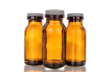 Three glass jars for medicine, macro, isolated on white background.