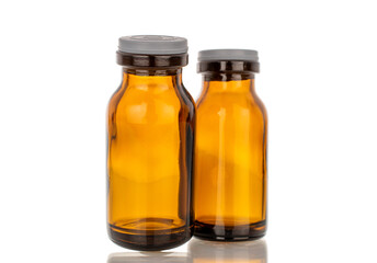 Two glass jars for medicine, macro, isolated on white background.