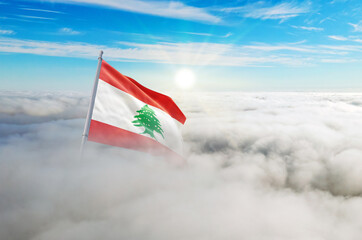 Lebanon flag aerial view in beautiful sky with clouds. Top-down drone shot at sunrise or sunset. Aerial bird's eye view of the flag with cloudscape.