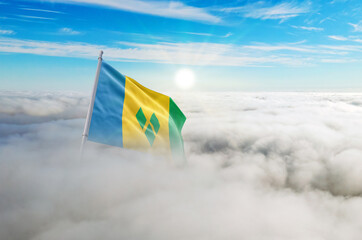 Saint Vincent flag aerial view in beautiful sky with clouds. Top-down drone shot at sunrise or...